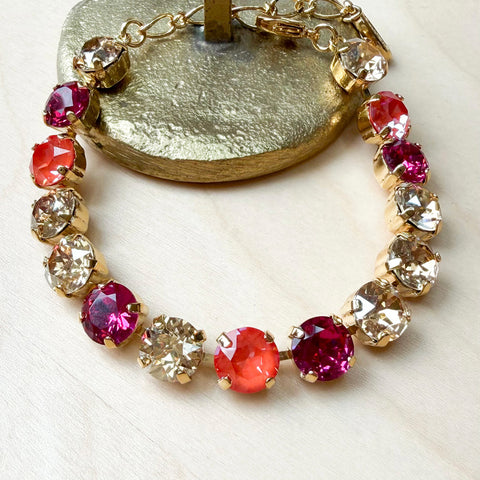 Gouden armband met fuchsia en oranje Swarovksi-kristallen